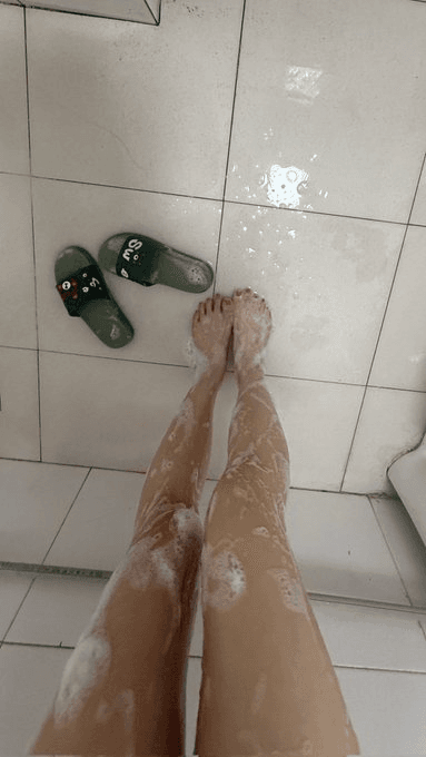 Close-up of a foot model applying lotion during her morning moisturizing ritual