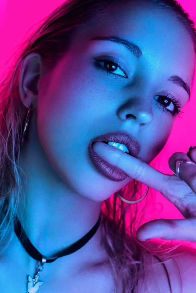 A futuristic woman interacting with a holographic screen showing analytics